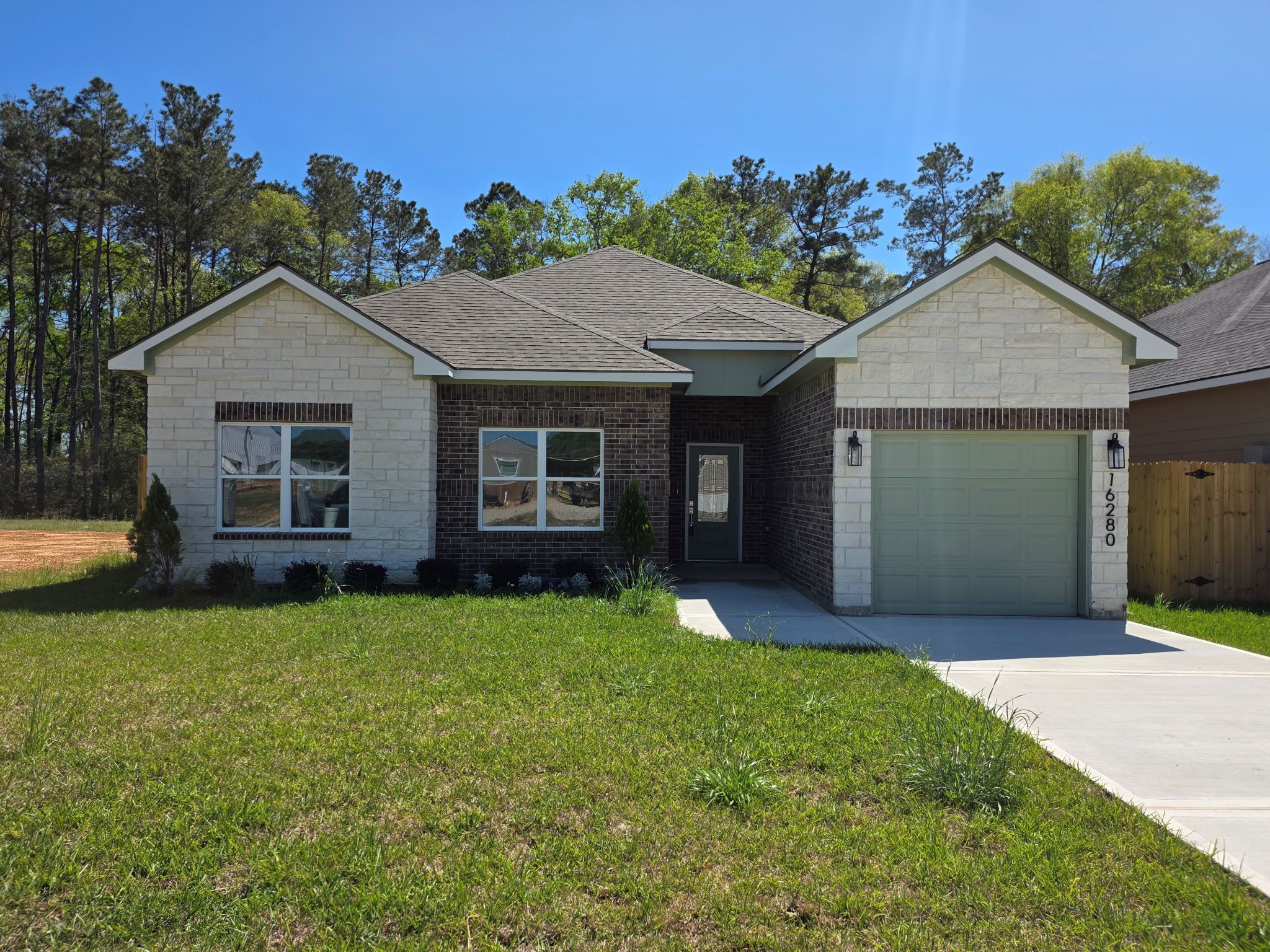 16280 Jeet Street Conroe, TX 77306 - Photo 4 of 31 a view of a house with a yard and potted plants