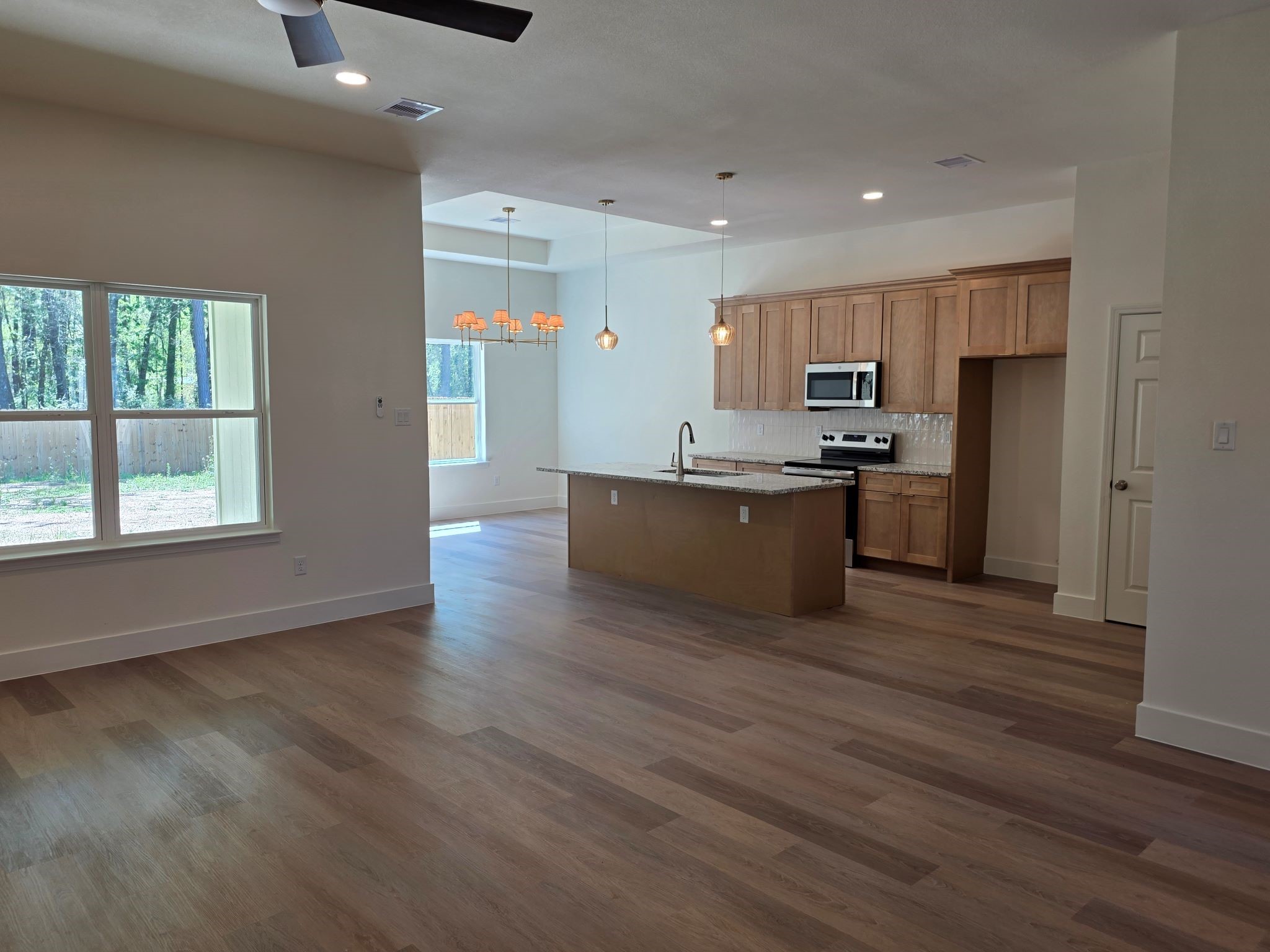 16280 Jeet Street Conroe, TX 77306 - Photo 7 of 31 a kitchen with stainless steel appliances a refrigerator and a stove top oven