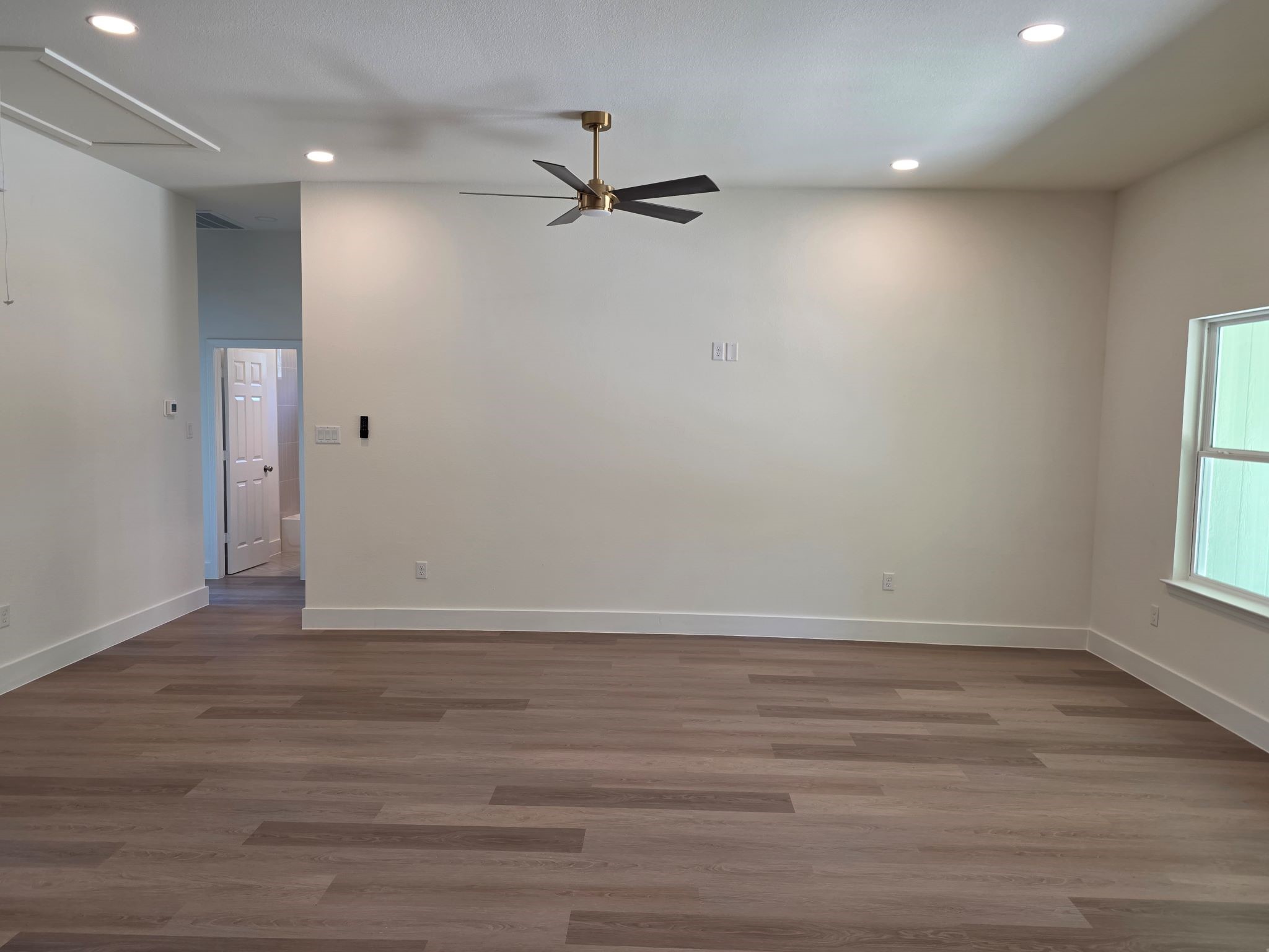 16280 Jeet Street Conroe, TX 77306 - Photo 8 of 31 wooden floor in an empty room with a window