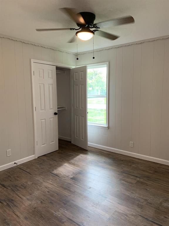 105 Still Street Kemp, TX 75143 - Photo 11 of 28 Unfurnished bedroom featuring dark wood-style flooring, a ceiling fan, and a closet