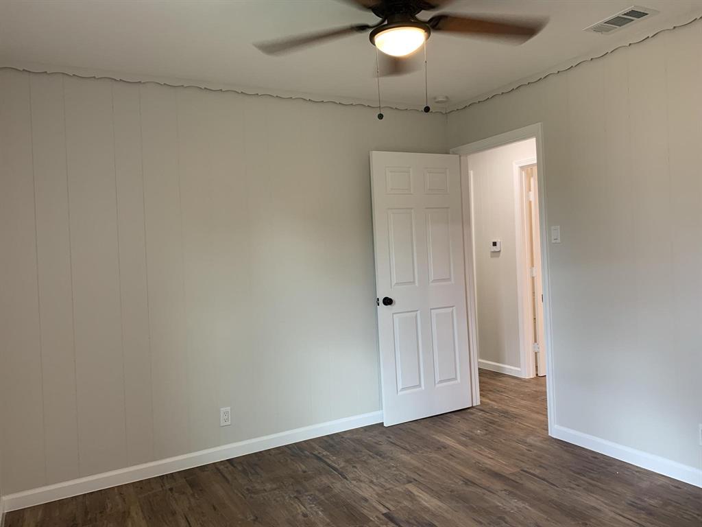 105 Still Street Kemp, TX 75143 - Photo 13 of 28 Spare room with a ceiling fan and dark wood-style flooring