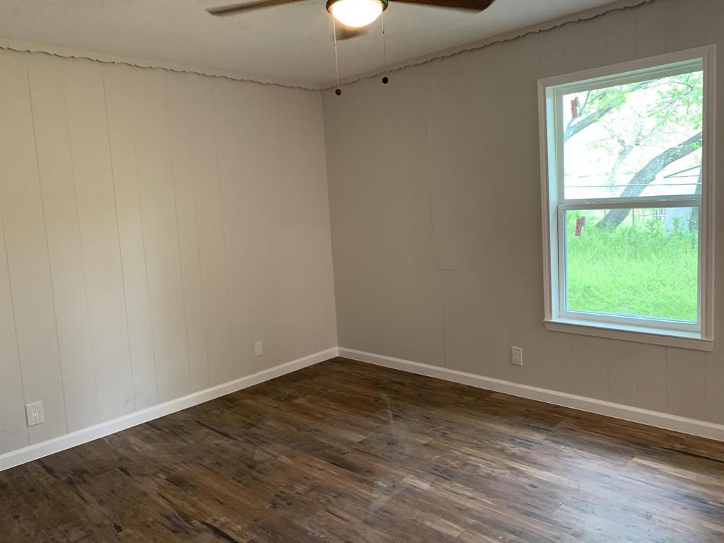 105 Still Street Kemp, TX 75143 - Photo 20 of 28 Spare room featuring dark wood-style floors and ceiling fan