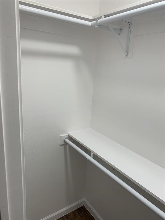 105 Still Street Kemp, TX 75143 - Photo 21 of 28 Walk in closet featuring dark wood-style flooring
