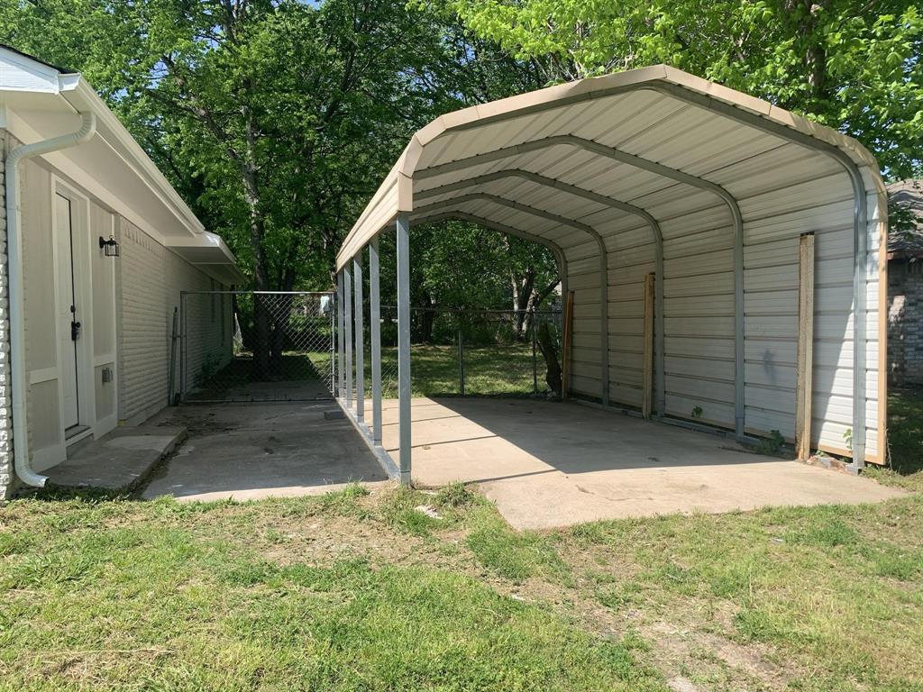 105 Still Street Kemp, TX 75143 - Photo 28 of 28 View of parking with a detached carport and view of wooded area