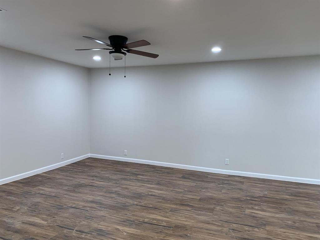 105 Still Street Kemp, TX 75143 - Photo 3 of 28 Empty room featuring dark wood-style flooring, a ceiling fan, and recessed lighting