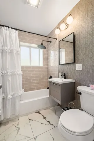 a bathroom with a toilet a sink and bathtub
