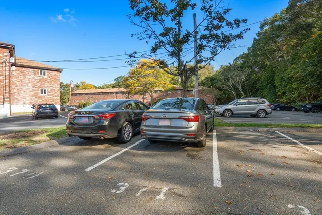 a view of a cars parked on the side of a street