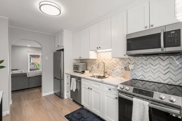 a kitchen with a sink stove and microwave