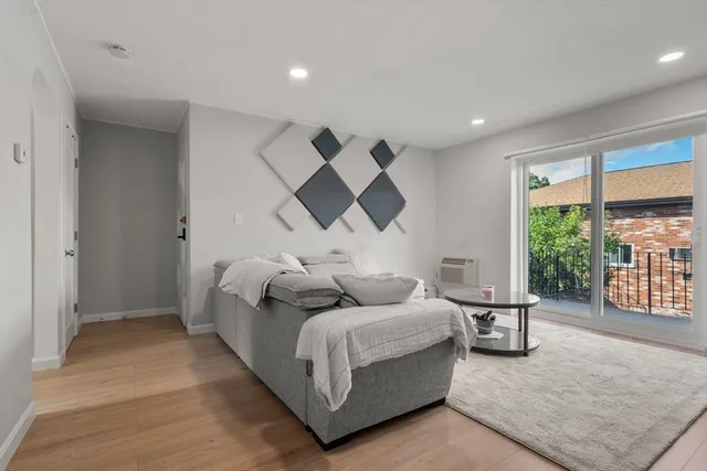 a living room with furniture and a large window