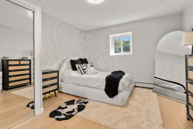 a bedroom with a bed and a painting on the wall