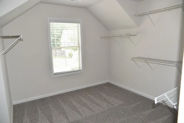 a view of a room with rack on the wall and a window