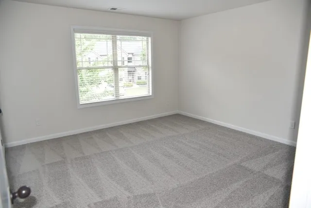 a view of a field with trees in the background