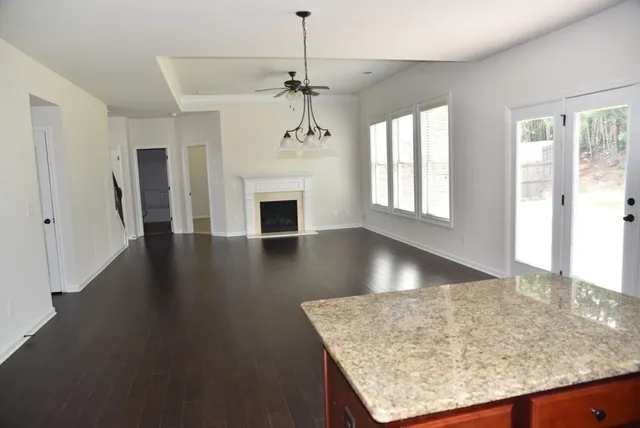 a view of a livingroom with a fireplace and window