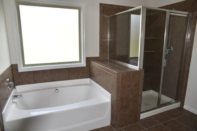 a bathroom with a bathtub and a shower