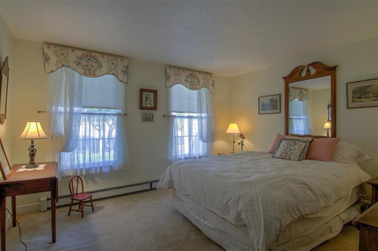 29 David Street Osterville, MA 02655 - Photo 20 of 26 a bedroom with a bed chair and wall paintings on the wall