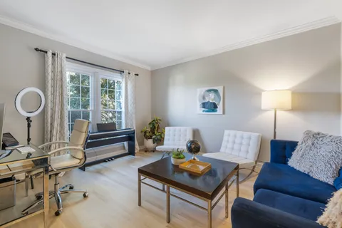a view of a dining room with furniture and window