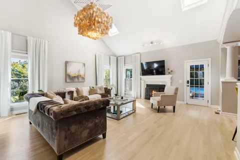 a view of a dining table chairs and chandelier