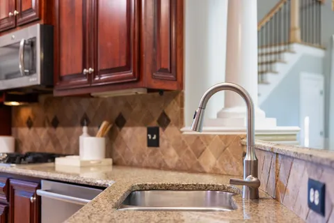 a living room with furniture large window and wooden floor