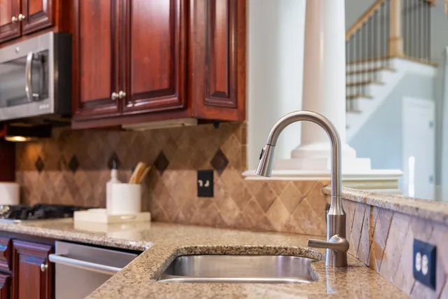 a living room with furniture large window and wooden floor