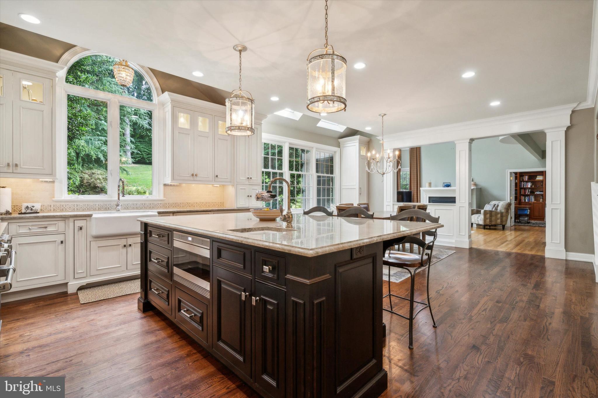 145 Biddulph Road Wayne, PA 19087 - Photo 14 of 38 a kitchen with stainless steel appliances granite countertop a kitchen island a stove a sink a center island and windows