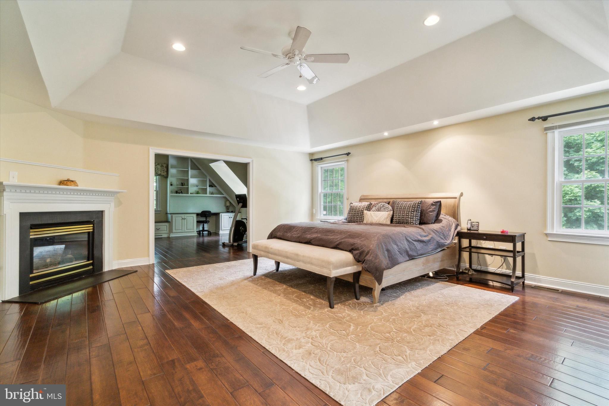 145 Biddulph Road Wayne, PA 19087 - Photo 19 of 38 a bedroom with a bed lamps and fireplace