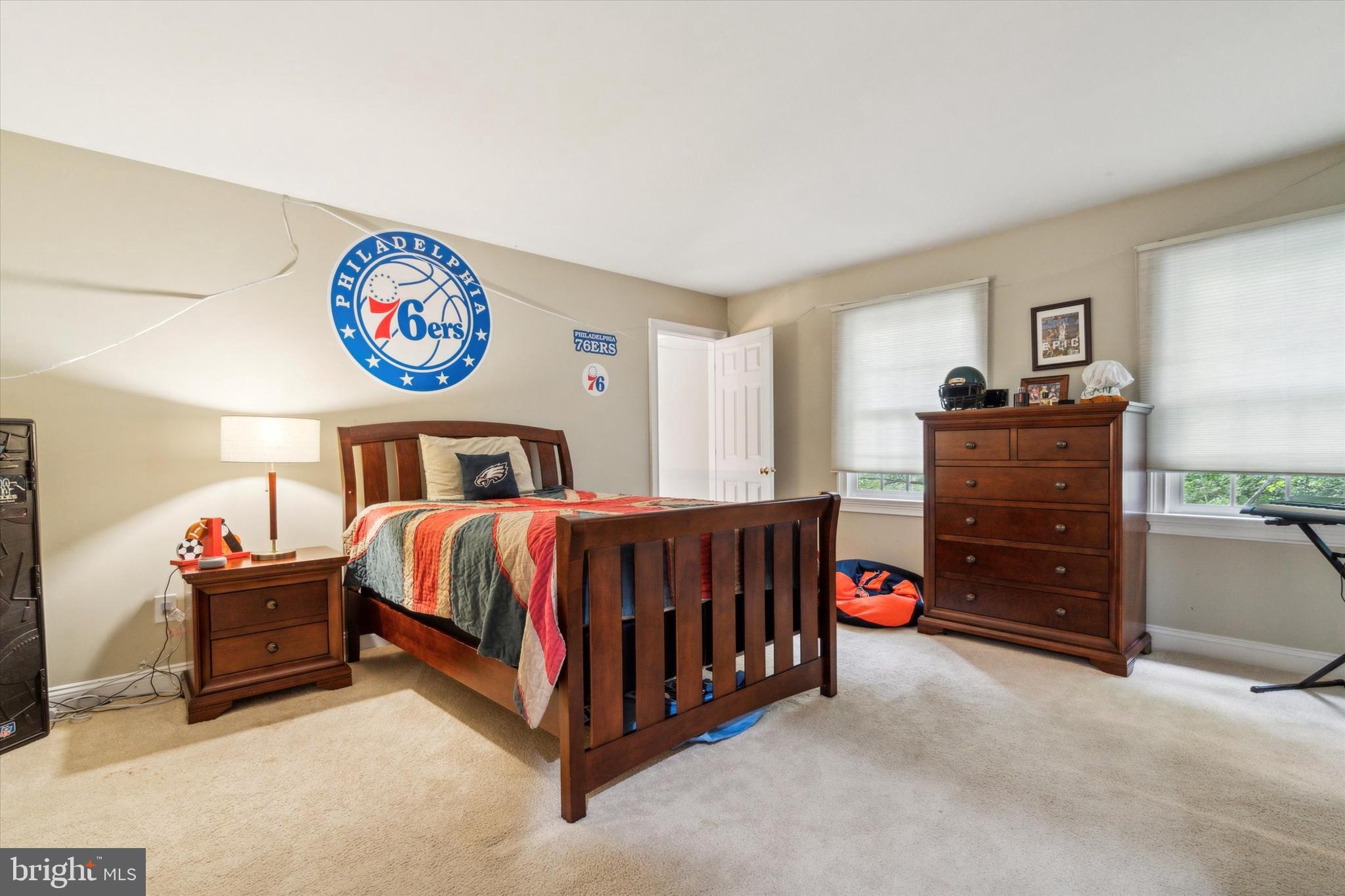 145 Biddulph Road Wayne, PA 19087 - Photo 24 of 38 a bedroom with a bed and a chandelier