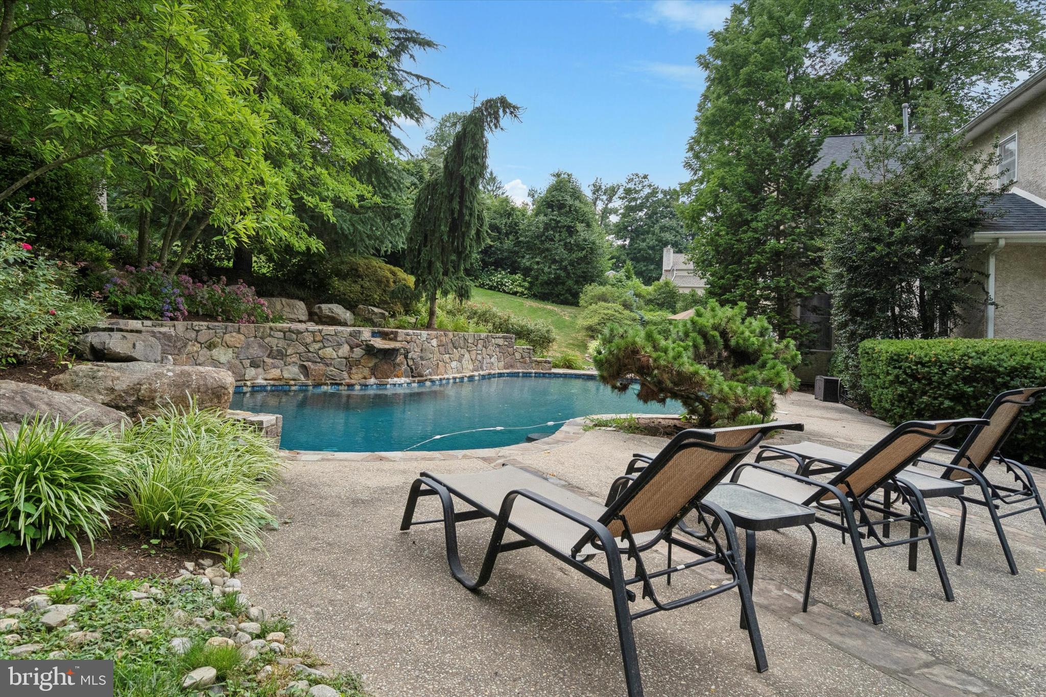 145 Biddulph Road Wayne, PA 19087 - Photo 33 of 38 a view of a lake with table and chairs and potted plants