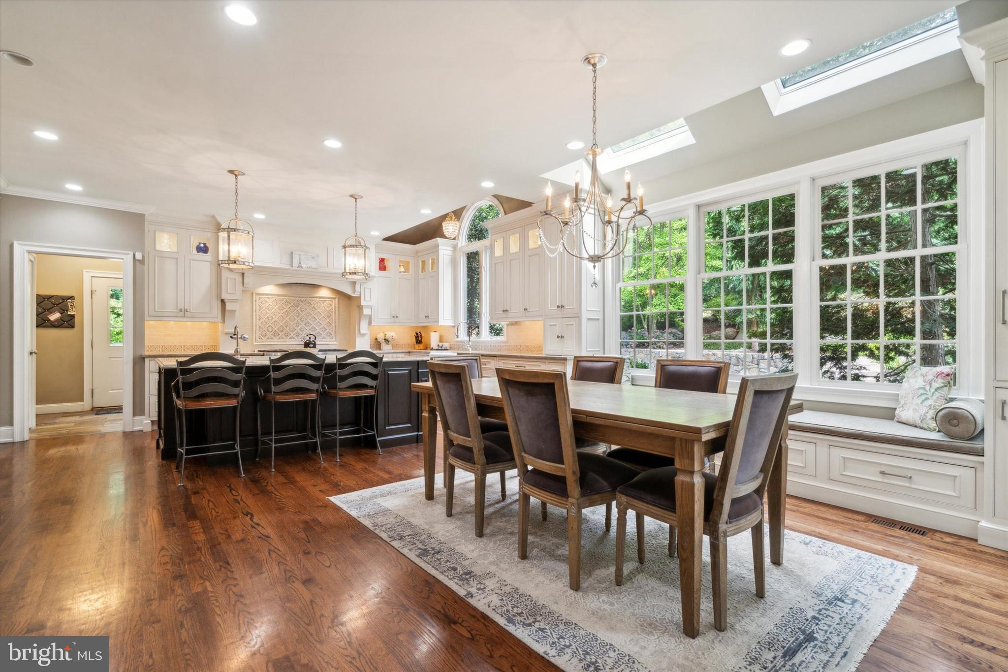 145 Biddulph Road Wayne, PA 19087 - Photo 9 of 38 a dining room with wooden floor a chandelier a wooden table and chairs