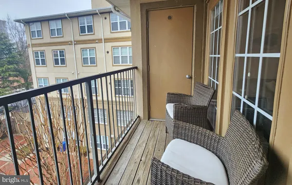 a balcony with table and chairs