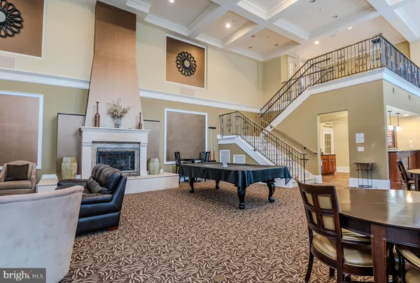 a living room with furniture a fireplace and a chandelier