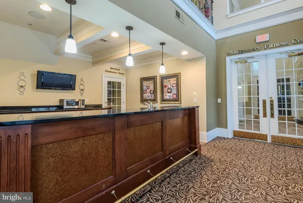 a living room with wooden floor and flat screen tv