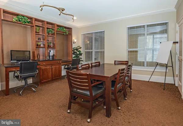 a dining room with a wooden table and chairs