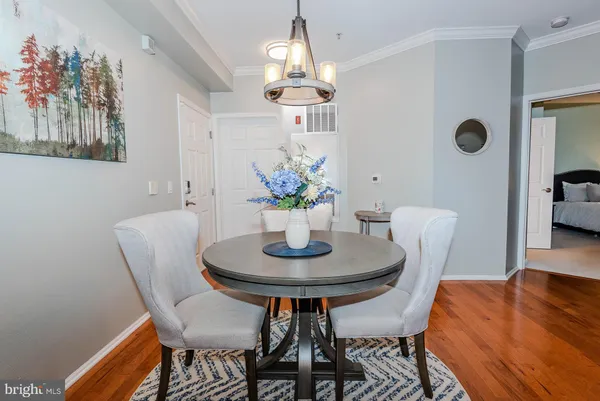 a dining room with furniture and wooden floor