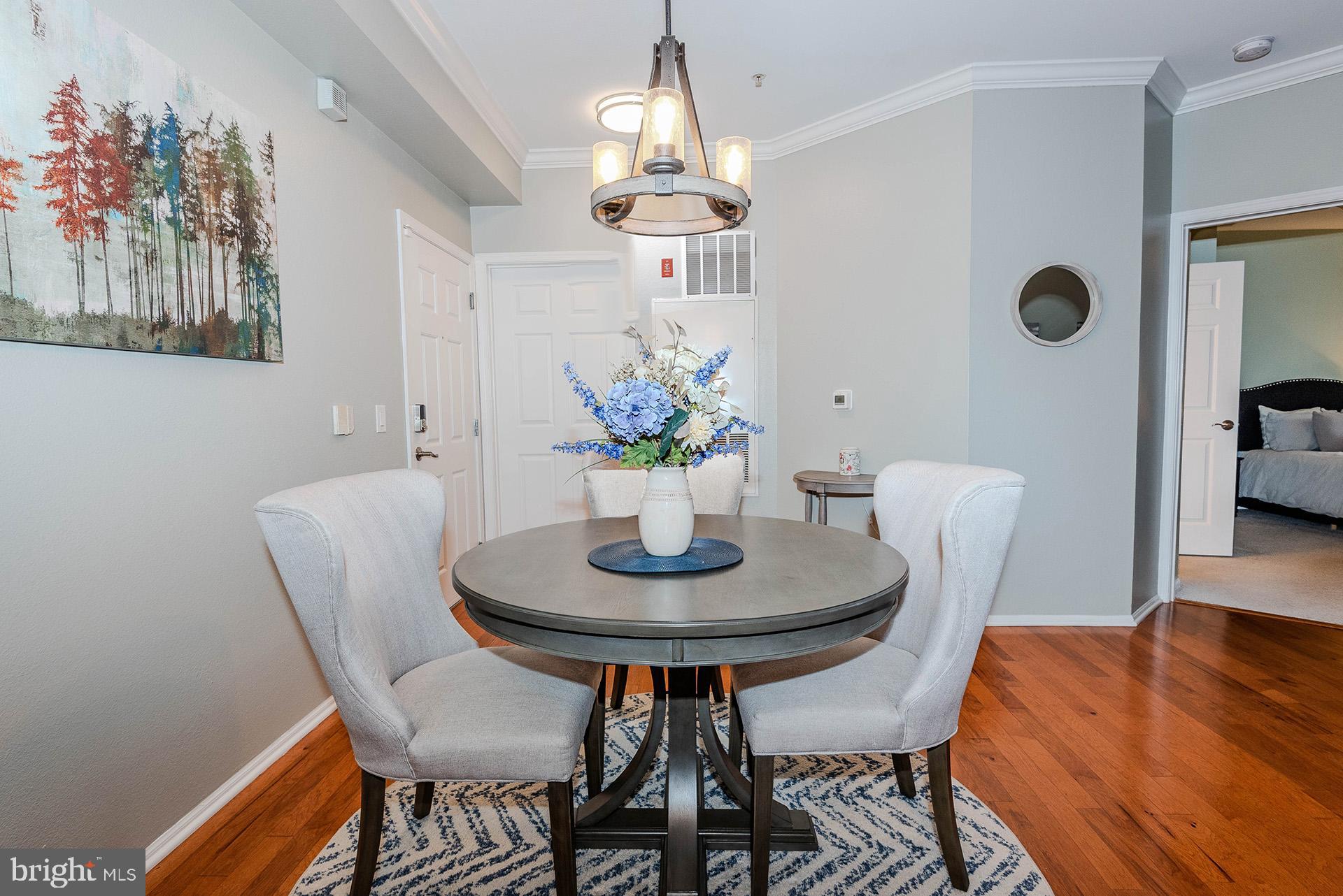 11800 Old Georgetown Road, Unit 1632 North Bethesda, MD 20852 - Photo 5 of 35 a dining room with furniture and wooden floor