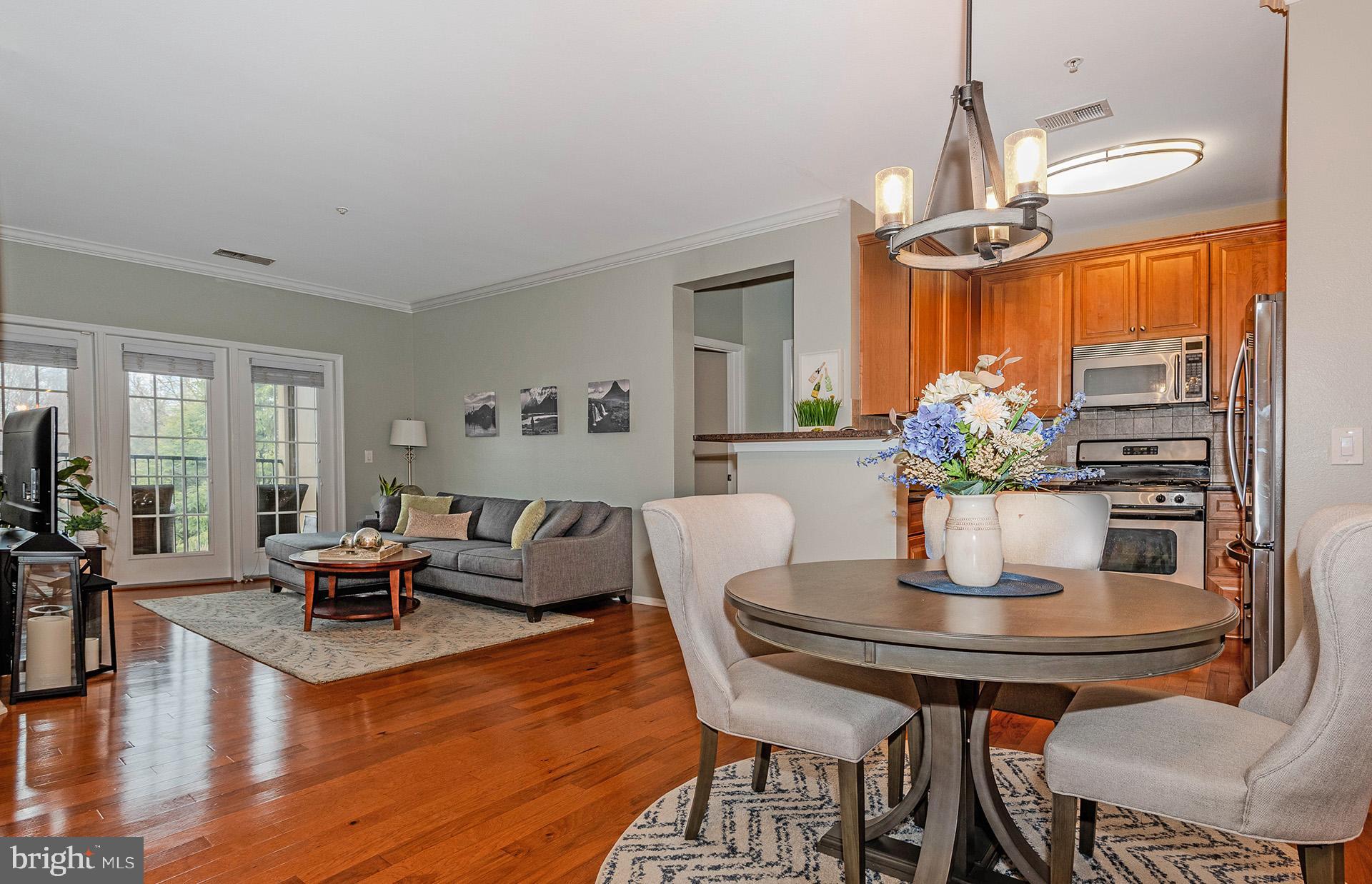 11800 Old Georgetown Road, Unit 1632 North Bethesda, MD 20852 - Photo 6 of 35 a living room with furniture wooden floor and a chandelier