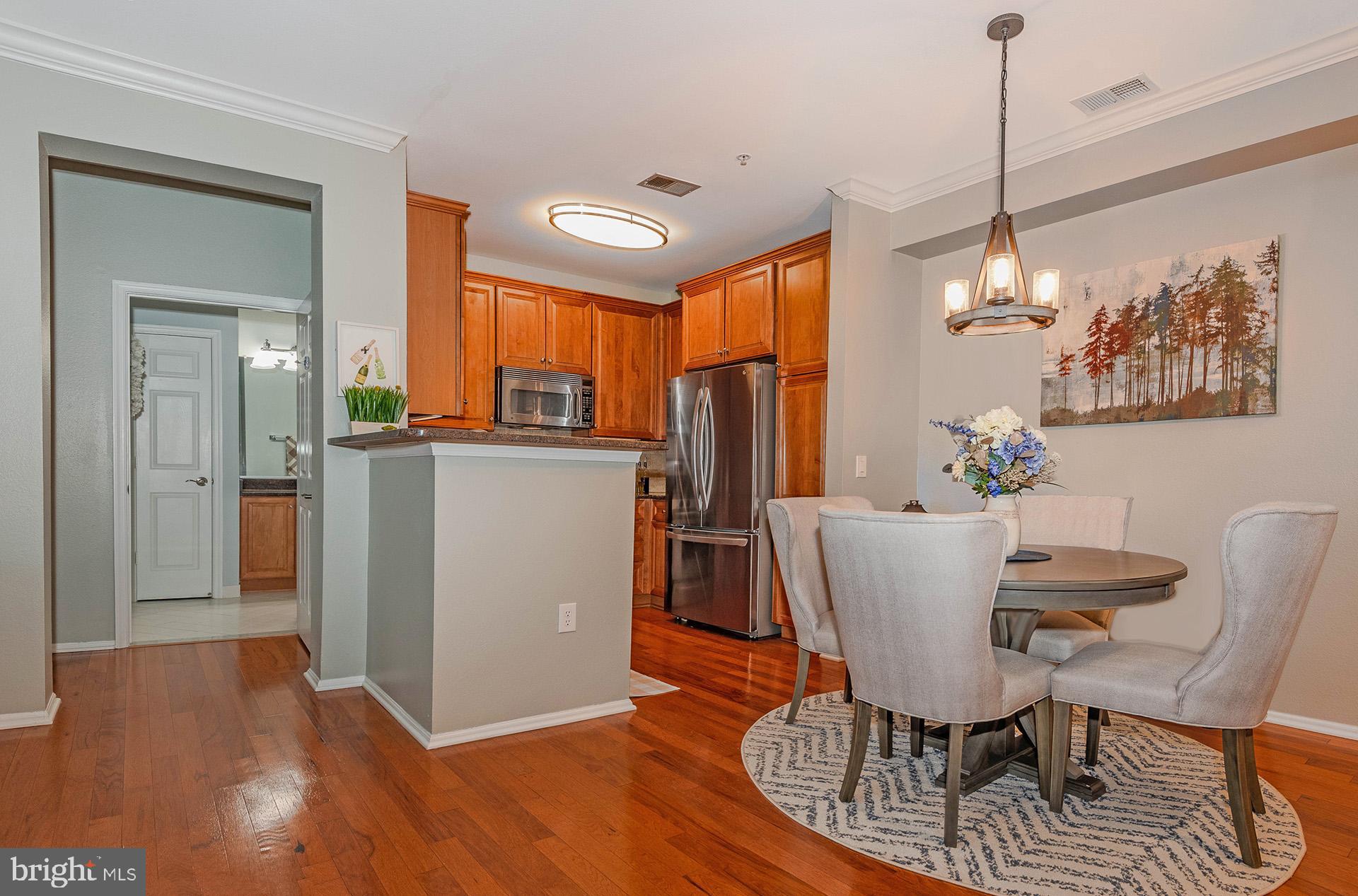 11800 Old Georgetown Road, Unit 1632 North Bethesda, MD 20852 - Photo 7 of 35 a dining room with furniture a chandelier and wooden floor