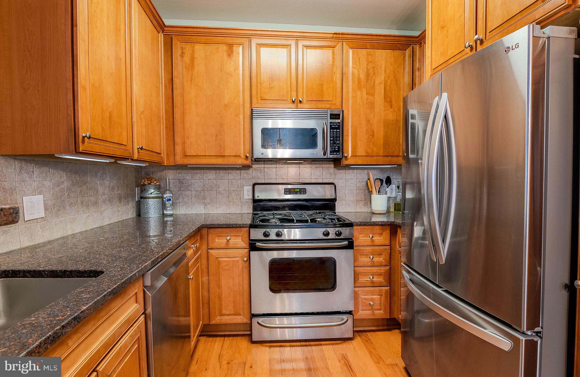 11800 Old Georgetown Road, Unit 1632 North Bethesda, MD 20852 - Photo 8 of 35 a kitchen with a stove a fridge and a sink
