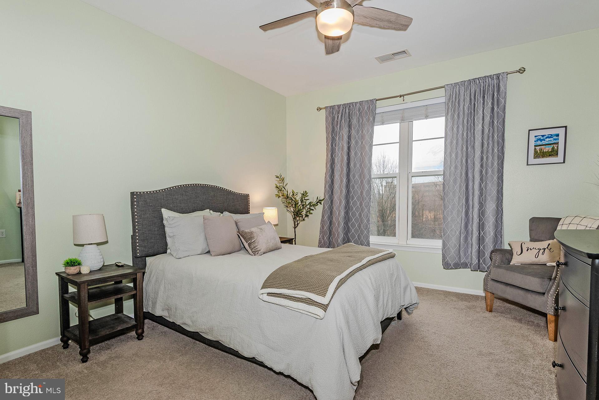 11800 Old Georgetown Road, Unit 1632 North Bethesda, MD 20852 - Photo 10 of 35 a bedroom with a bed and a chandelier