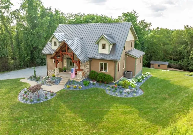 a view of an house with backyard space and balcony