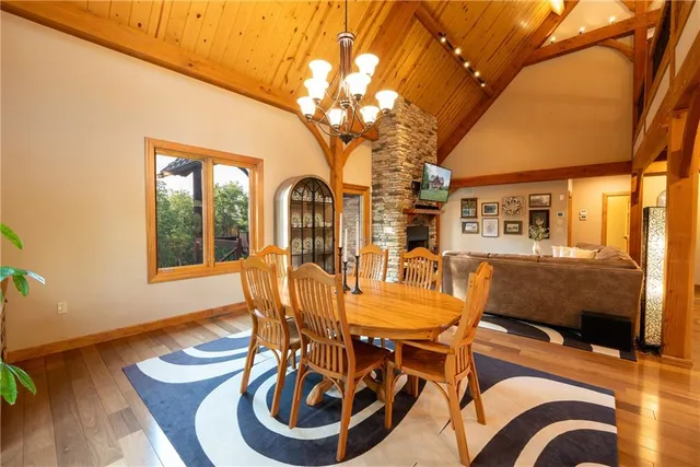 a view of a patio with couches table and chairs and wooden floor