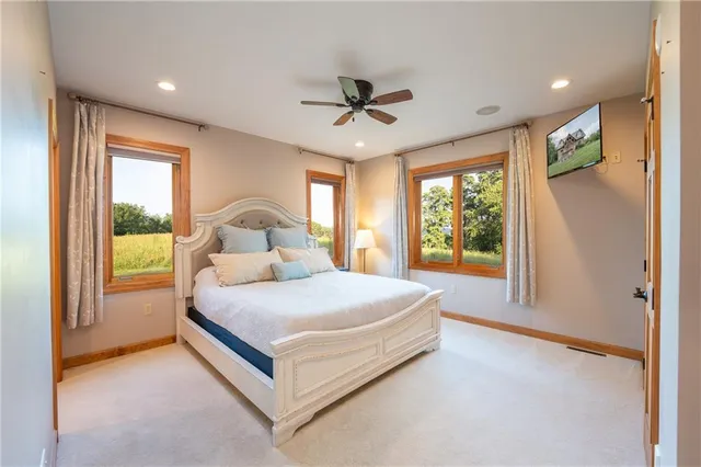 a spacious bedroom with a bed and a chandelier