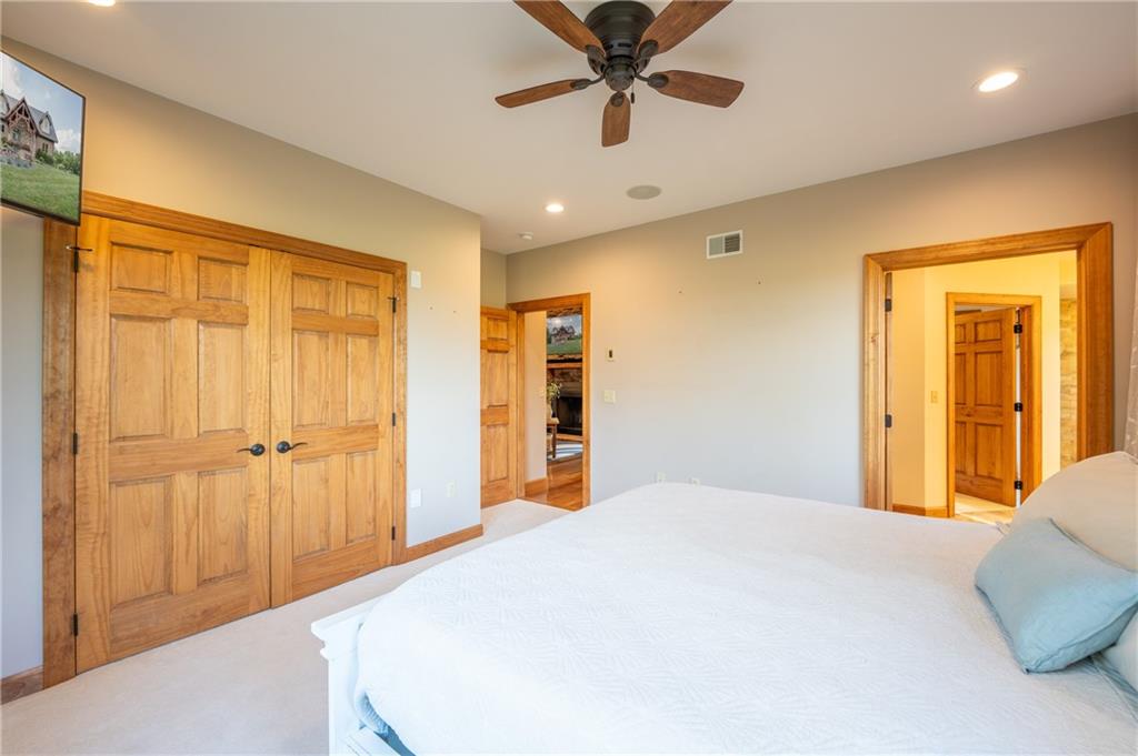 2780 Ipnar Road Irwin, PA 15642 - Photo 18 of 40 a bedroom with a large bed and a chandelier