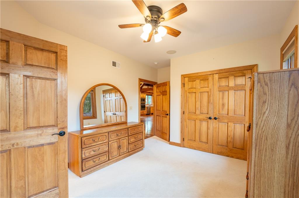 2780 Ipnar Road Irwin, PA 15642 - Photo 19 of 40 a spacious bedroom with a bed and a chandelier