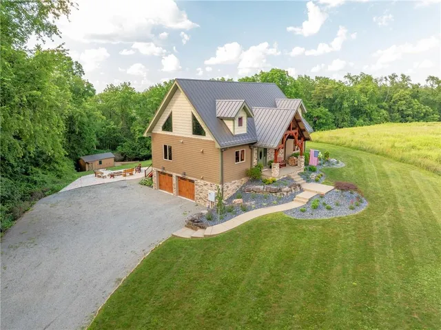 a aerial view of a house with a yard table and chairs