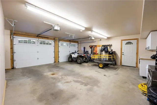 a view of patio with table and chairs under an umbrella with a barbeque