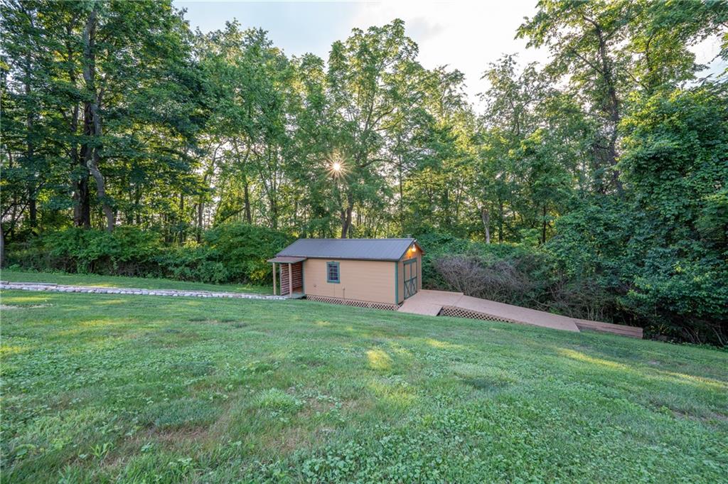 2780 Ipnar Road Irwin, PA 15642 - Photo 33 of 40 a backyard of a house with plants and large trees