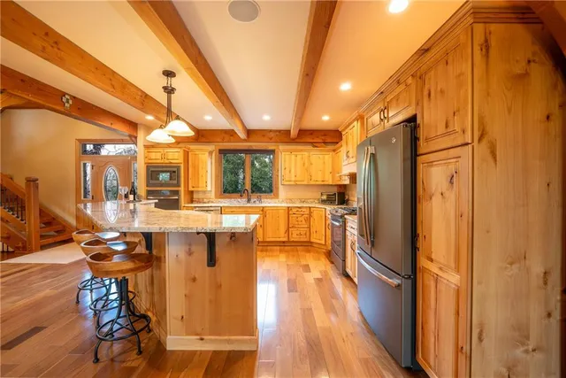 a dining room with furniture a floor to ceiling window and potted plants