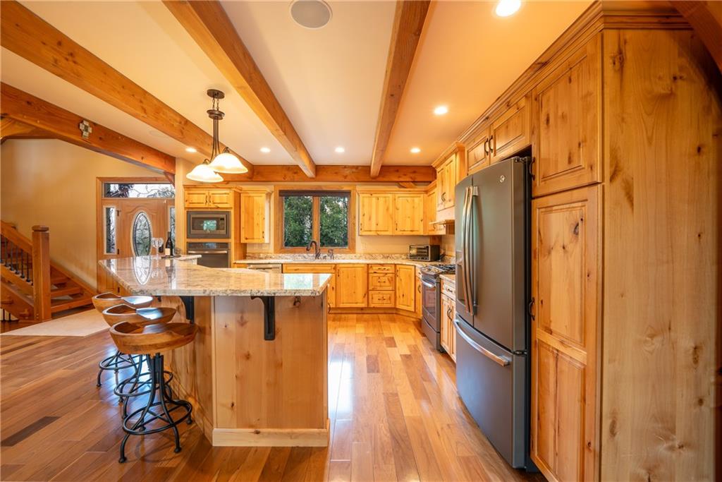 2780 Ipnar Road Irwin, PA 15642 - Photo 9 of 40 a view of kitchen with stainless steel appliances refrigerator stove and wooden floor
