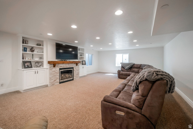 1288 North Horizon View Loop Elk Ridge, UT 84651 - Photo 30 of 40 Living area with light carpet, recessed lighting, and a fireplace