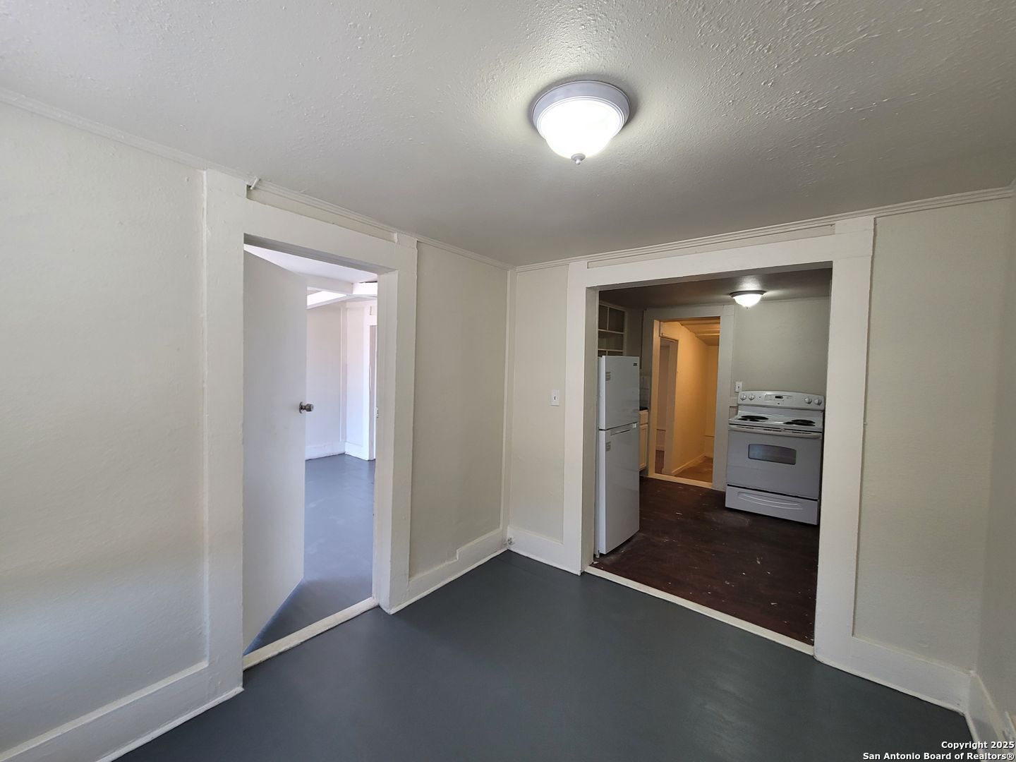 an empty room with a bathroom and a sink